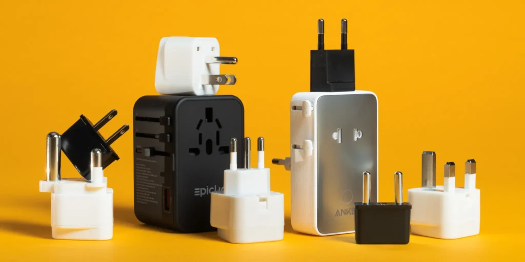 Comparison of regional power adapters and official product box contents.